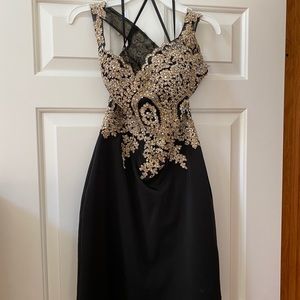 off the shoulder black and gold short dress.